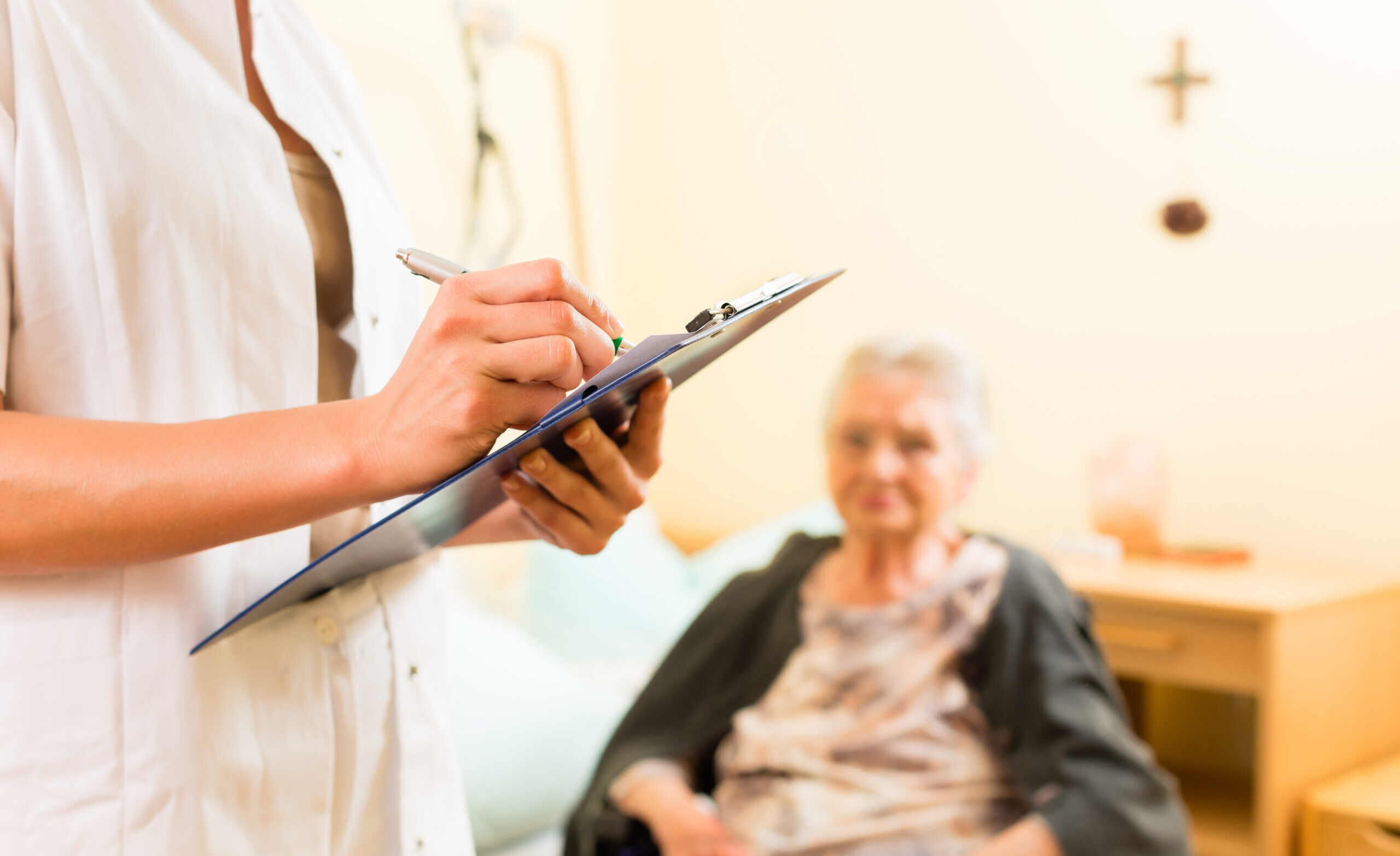Young nurse and female senior in nursing home