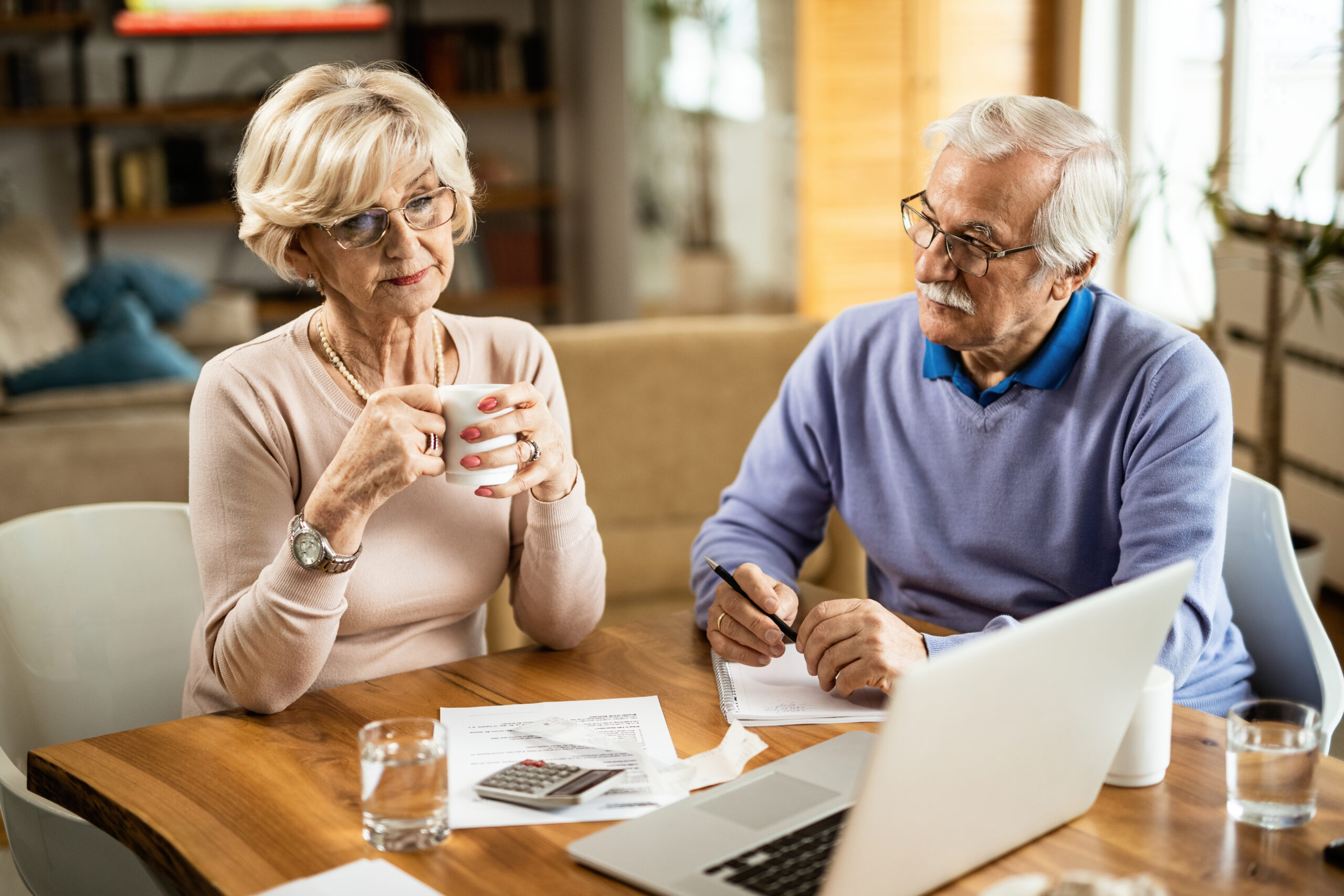 Pensive mature couple going through home finances.